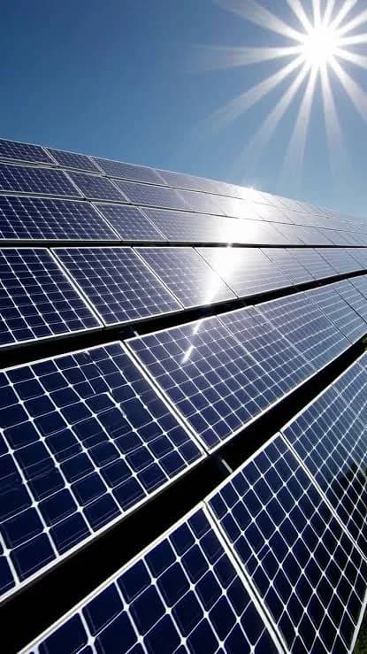 Rows of solar panels under a bright sun